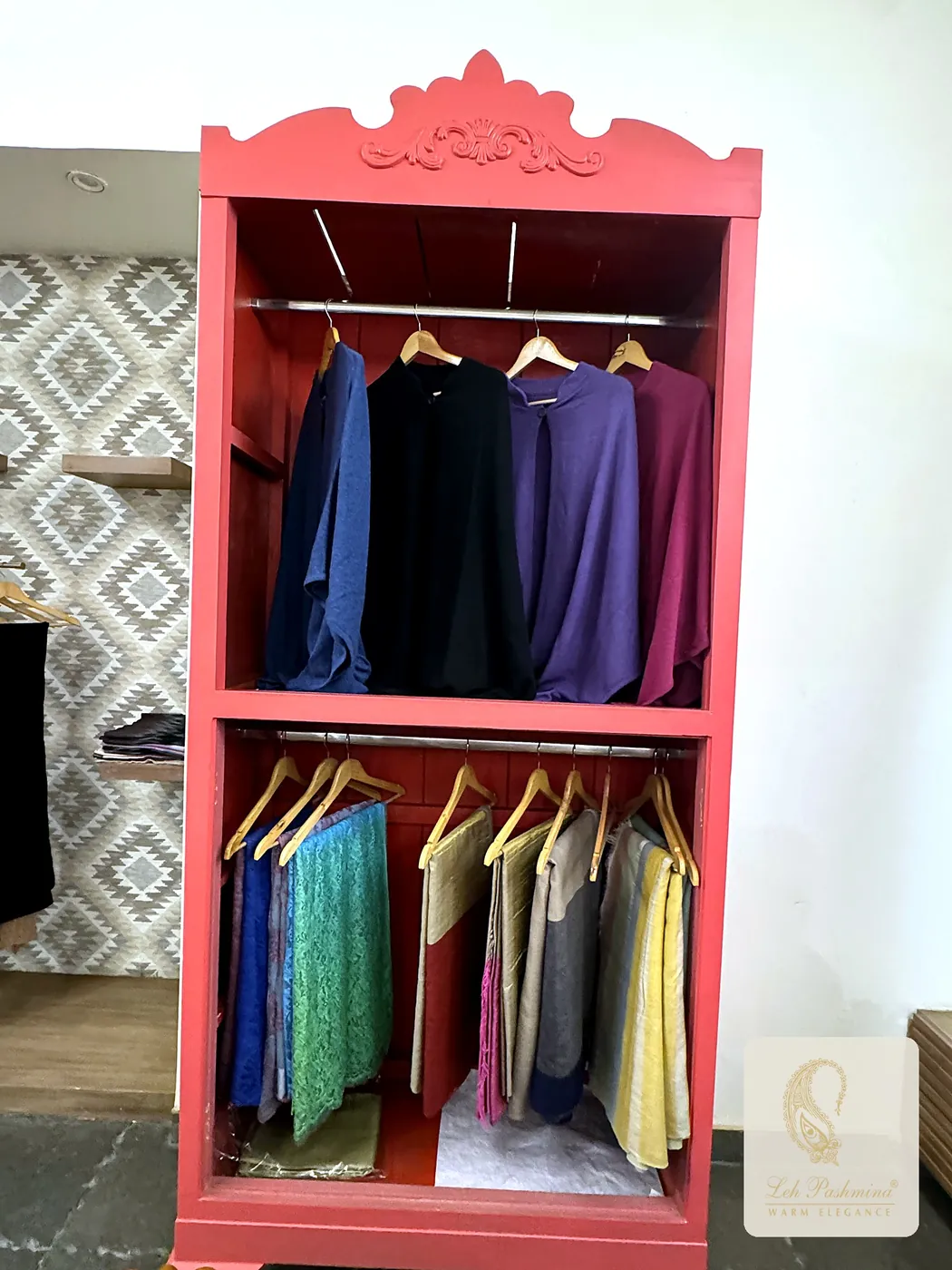 Red wardrobe with stoles and knitwear
