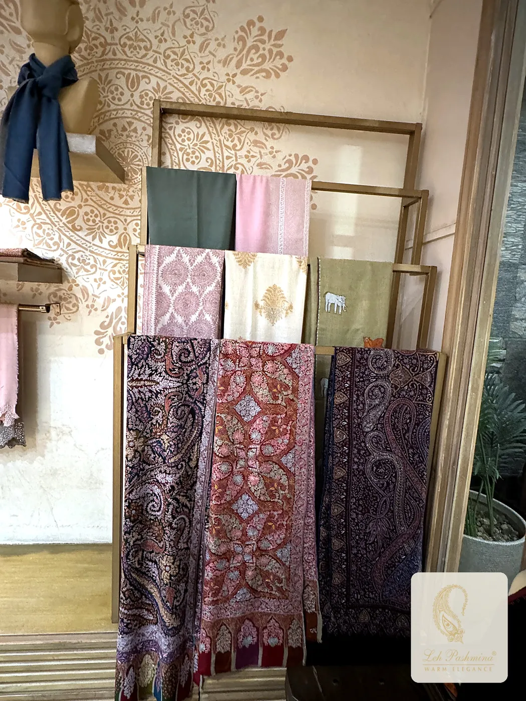 Jamawar stoles on a rack in the Leh Pashmina showroom, Kavi Nagar